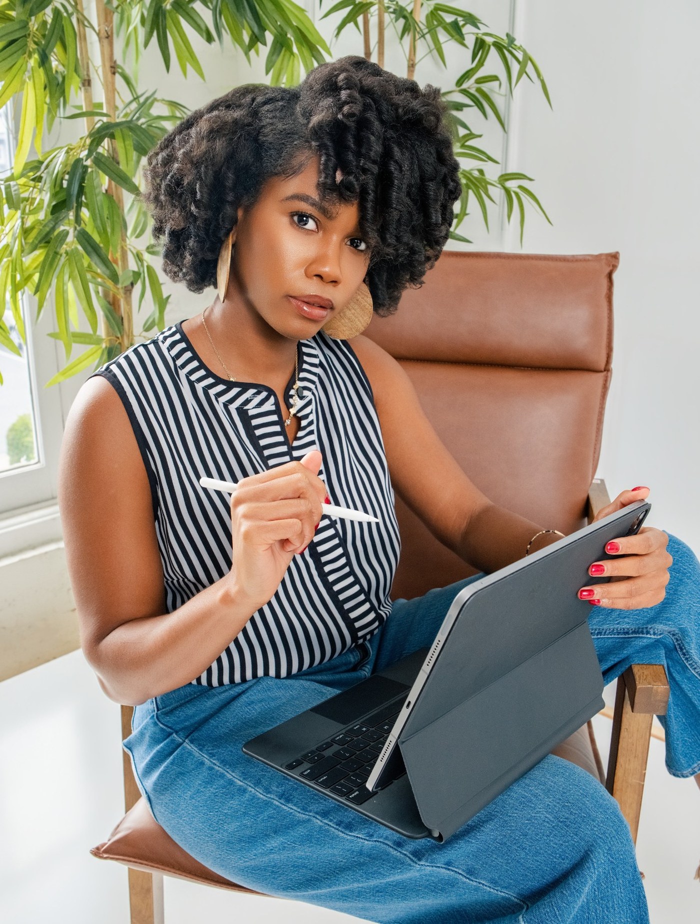 Tyra Jean, founder of Data Viz For Good, working with a tablet